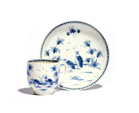 A Worcester blue and white coffee cup and saucer  c.1770-80, painted with the Two Quail pattern, a large moth in flight above