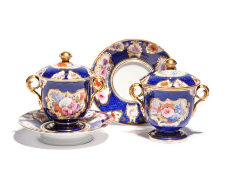 A pair of Coalport cups with covers and stands  c.1805, painted perhaps by William Billingsley, in the Worcester manner with 