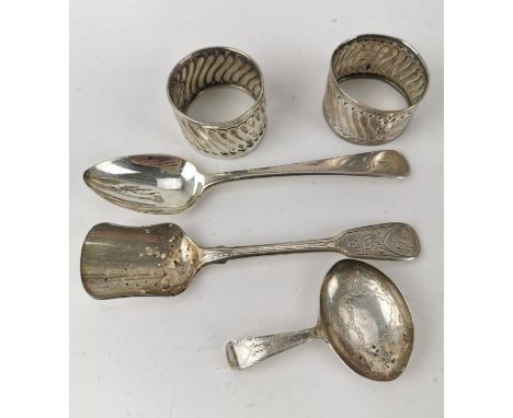 A small group of silver to include three George III spoons, one of the a caddy spoon, and two napkin rings (marks rubbed), co