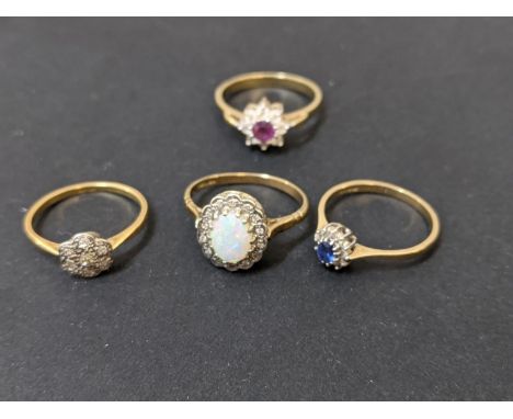 Two 9ct gold 4.2g, and one 18ct gold ring 1.85g, set with stones, and a yellow metal ring 