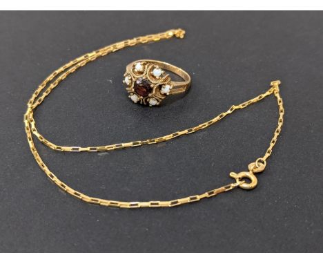 A 9ct gold ring set with a garnet and opals and a 9ct gold necklace, 6.1g. Location:Cab 