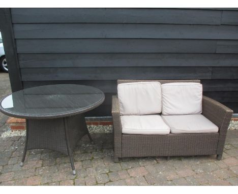 A faux wicker dining table of circular form, together with a two seater sofa, Location: G 