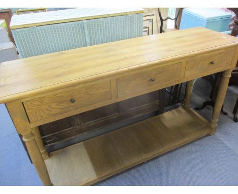 A modern light oak side unit having three drawers and a shelf below 85cm h x 148cm w x 45cm d Location: LAM 