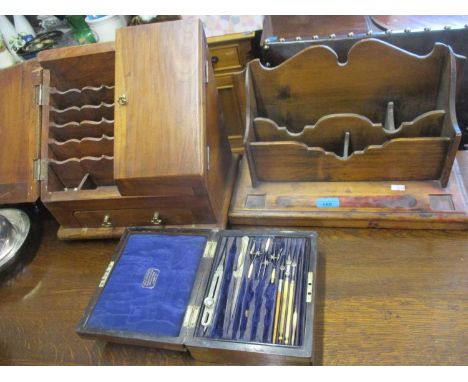 An early 20th century stained pine desk tidy, a stationary box and a cased Archbutt geometry set. Location:RAB 
