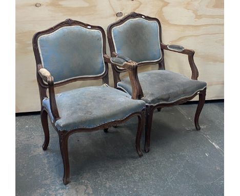 A pair of Louis XVI style fauteuil, 19th century, upholstered in a light blue fabric, the carved frames with faceted cabriole
