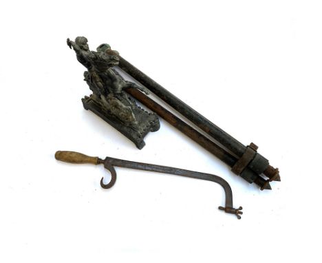 An antique tripod, cast metal figure of knight on horseback, and an antique hacksaw with turned wooden handle