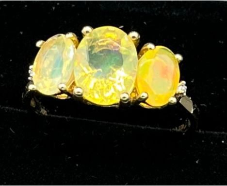 10ct yellow gold ladies ring set with three opalescent style stones. [Ring size R] [2.66Grams] 