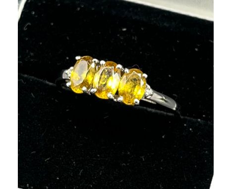 10ct white gold ladies ring set with three yellow tourmaline stones off set by a diamond to each shoulder. [Ring size R1/2] [