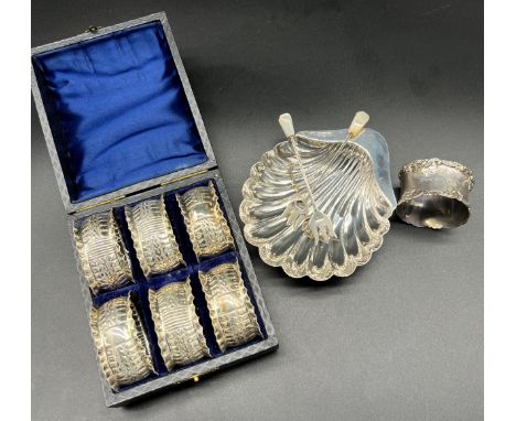 A Boxed set of six Sheffield silver napkin rings, Sheffield silver scallop shell dish designed with shell feet. Birmingham si