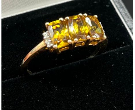 10ct yellow gold ladies ring set with three yellow tourmaline stones off set by diamond shoulders. [Ring size P] [2.43Grams] 