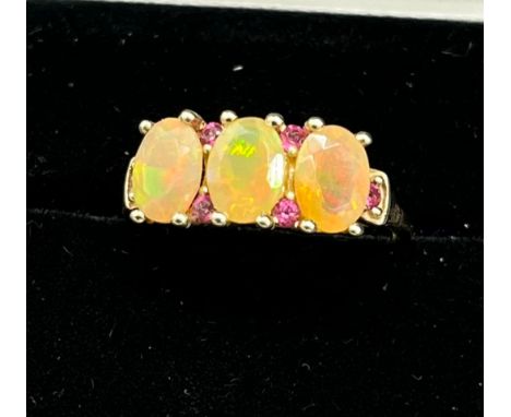 10ct yellow gold ladies ring set with three opalescent style stones off set by pink Iolite stones. [Ring size P] [2.47Grams] 