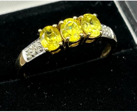 9ct yellow gold ladies ring set with three green tourmaline stones off set with diamond shoulders. [Ring size R1/2] [2.11gram