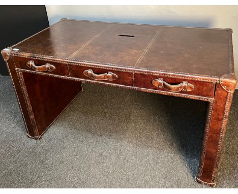 Contemporary leather trunk design desk [Timothy Oulton], the rectangular top above three short drawers, detailed with wooden 