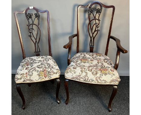 Art Nouveau chair, the shaped back with central moulded foliate splat, above open arm supports and cushioned seat, raised on 