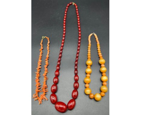 Three vintage necklaces to include coral necklace, glass ball effect necklace and cherry amber style graduating bead necklace