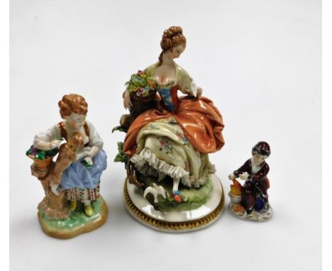 A Capodimonte porcelain figure of a lady and birds, on a circular gilt highlighted base, 20cm high, a Dresden figure of a you