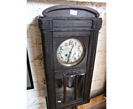 Oak cased 8-day wall clock, striking on a gong with glass door enclosing pendulum