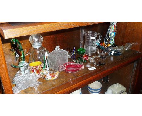 Art Glass handmade animals and fish, a Murano clown, bottle shaped as a pistol, etc. (one shelf)