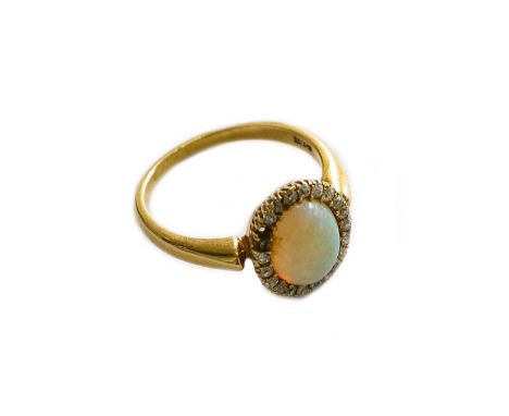 An opal and diamond cluster ring, stamped '18CT', finger size Q (a.f.)Gross weight 4.7 grams.