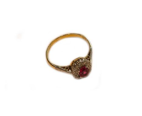 An 18 carat gold ruby and diamond cluster ring, finger size IGross weight 2.6 grams.