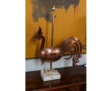 A brass and copper weather vane formed as a Cockerill with riveted globular body and open fretwork tail feathers, now mounted