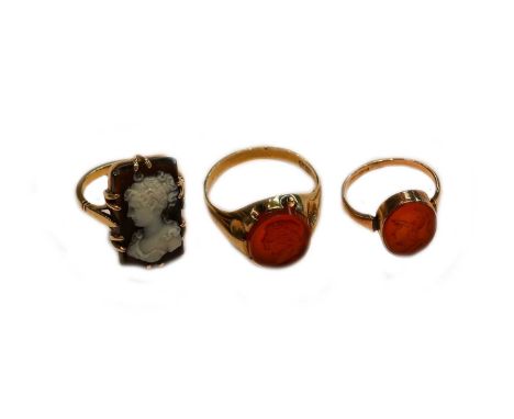 A 9 carat gold cameo ring, finger size U; a cameo ring, unmarked, finger size K; and a hardstone intaglio ring, finger size K