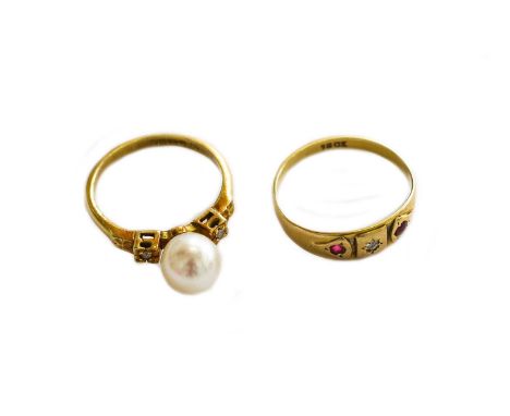 A ruby and diamond three stone ring, stamped '18CT', finger size M; and an 18 carat gold cultured pearl ring, finger size MGr