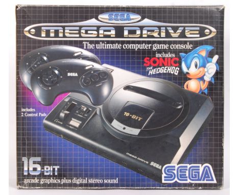 An original vintage Sega Mega Drive 16-bit games console. Appears complete with all cables (no game), within the original box