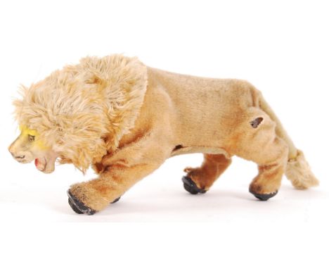 A charming rare vintage Marx Toys made tin fur covered clockwork lion. With original key. When wound, the lion walks, stops a