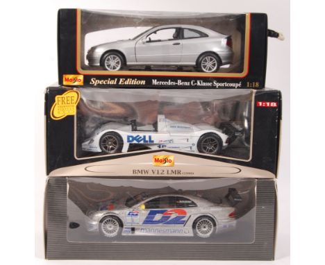 A collection of 3x assorted 1:18 scale precision diecast model sports cars. All appear mint and unused, within the original d