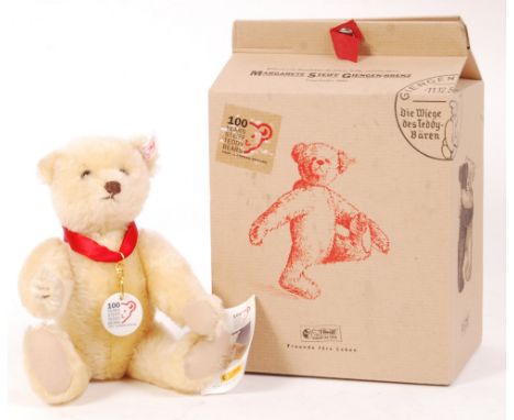 A 20th century Steiff teddy bear - ' 100 Years '. Blonde mohair, with pronounced snout and humped back. Complete with certifi