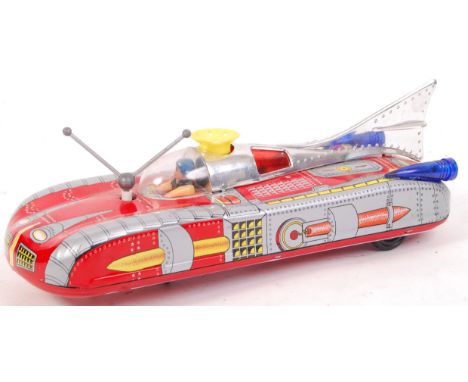 A vintage Japanese (or possibly Russian) made tinplate battery operated spaceship. Lights, sound and air-blowing feature. Ful