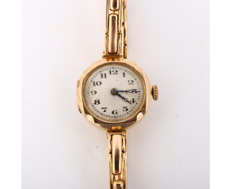 A lady's 9ct gold mechanical bracelet watch, silvered dial with Arabic numerals, blued steel hands and 9ct expanding bracelet