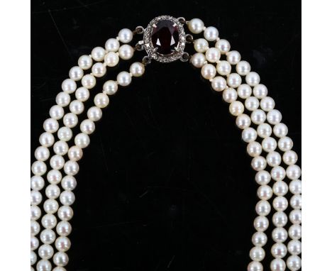 A Vintage triple-strand pearl necklace, with unmarked white metal garnet and diamond cluster clasp, necklace length 30cm, 28g
