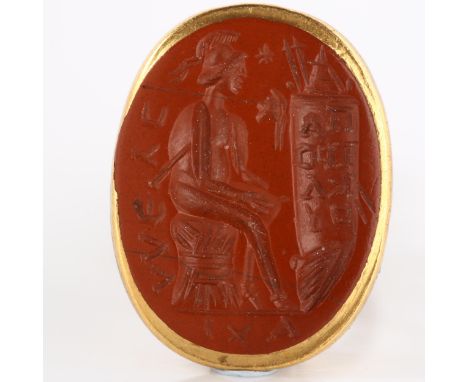 An Ancient Roman red jasper ring stone, possibly depicting Minerva with scroll of text, intaglio carved, in later Victorian u