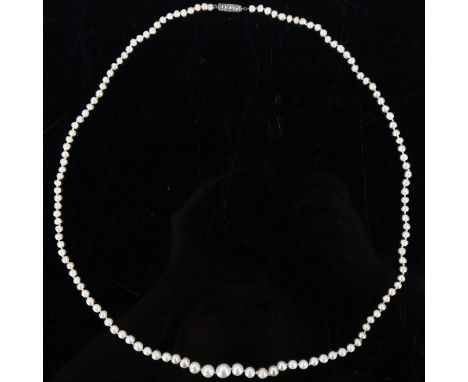 A natural pearl necklace, the 129 graduated pearls measuring 6.6mm - 7.2mm to 3.3mm, to a rose-cut diamond set clasp, necklac