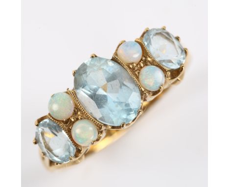 A modern 9ct gold blue topaz and opal half hoop ring, set with oval mixed-cut topaz and round cabochon opal, setting height 8