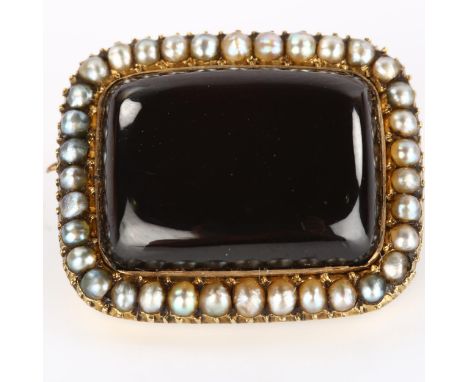 A Victorian garnet and pearl cluster memorial brooch, unmarked gold settings with rectangular cabochon garnet and split pearl