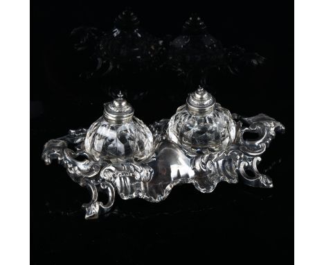 A Victorian silver Rococo style desk ink stand, with original fitted glass ink wells and pen tray, by John Harrison & Co, hal