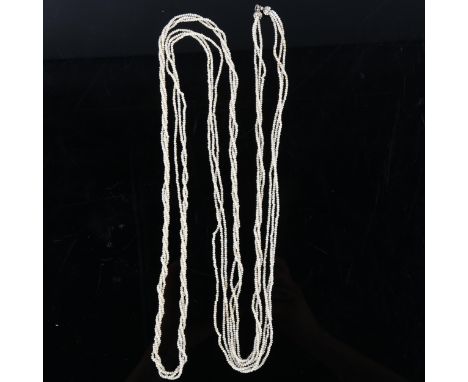 A long triple-strand seed pearl torsade necklace, with unmarked white metal old-cut diamond set clasp, necklace length 140cm,