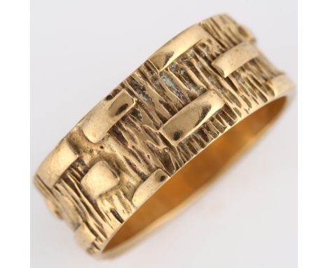 A mid-20th century 9ct gold wedding band ring, textured bark and block design, maker's marks PLS, hallmarks London 1969, band