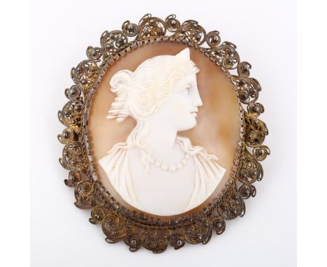 A Victorian shell cameo brooch, depicting profile of Greek lady, in unmarked silver filigree frame, brooch height 60.2mm, 18.