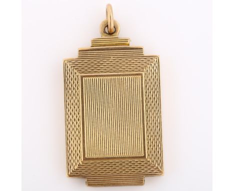 An Art Deco 9ct gold photo locket pendant, stepped rectangular form with engine turned decoration and fall-front, maker's mar