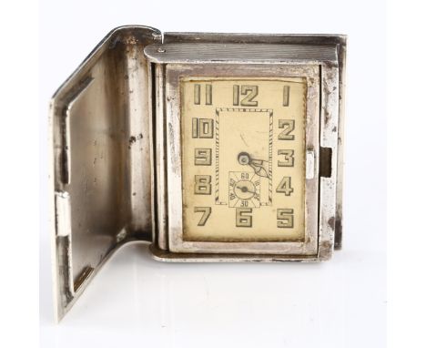 An unusual Art Deco novelty sterling silver and crocodile leather book travelling clock, silvered dial with Arabic numerals, 