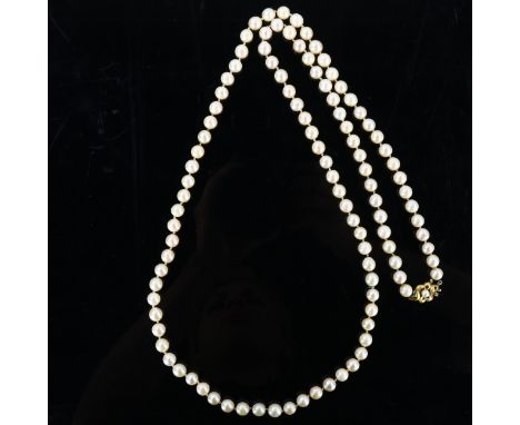 A long single-strand cultured pearl necklace, with unmarked gold pearl and emerald textured clasp, necklace length 90cm, 71gC