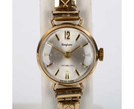 BINGHAM - a lady's 9ct gold mechanical bracelet watch, silvered dial with gilt arrowhead hour markers and gold plated expandi