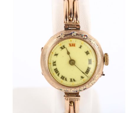 A First World War Period 9ct rose gold mechanical bracelet watch, white enamel dial with Arabic numerals, floral enamel engin
