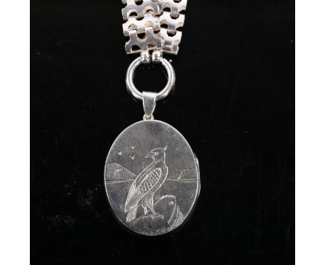 A Victorian bird of prey photo locket pendant necklace, unmarked silver settings on unmarked white metal fancy link collar ch
