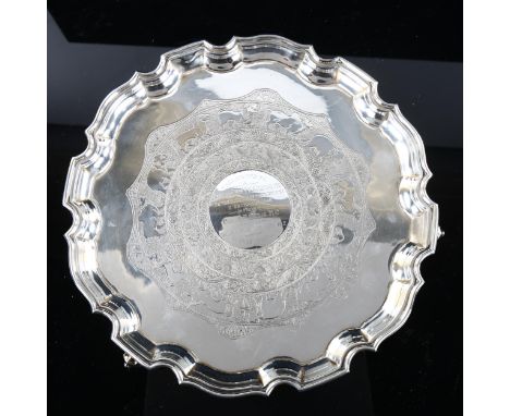 A George V silver salver, circular form with scalloped rim and Indian inspired engraved animal decoration, with military rela