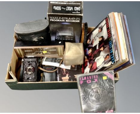 A box containing vintage cameras, vintage desk clock, a pair of Scheffel binoculars, program recorder, small quantity of LP r
